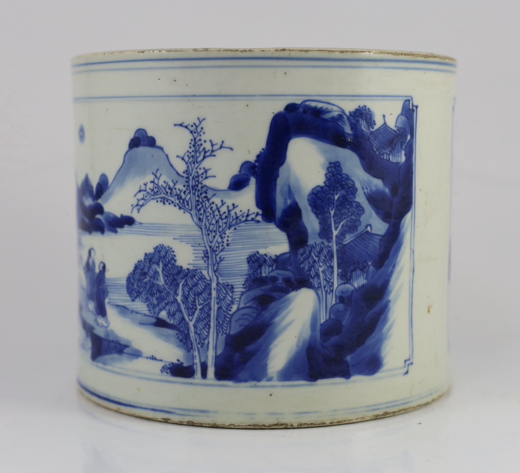 A Chinese blue and white ‘landscape’ brushpot, bitong, Kangxi period, 17.8cm diameter, 15.2cm high, fritting to edges